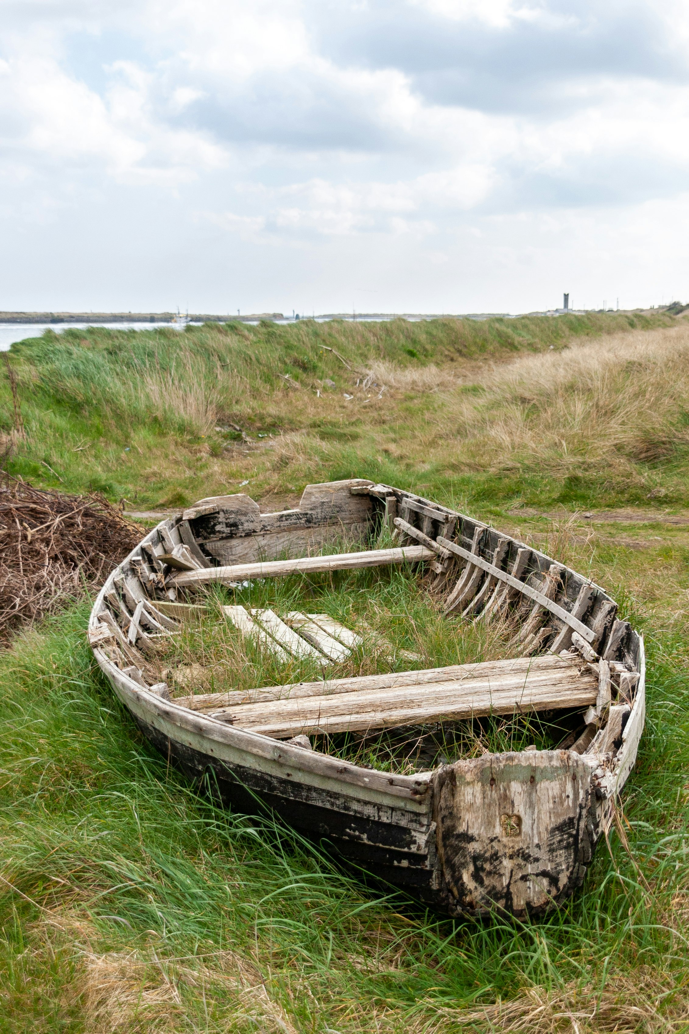 brown wooden boat on green grass field during daytime